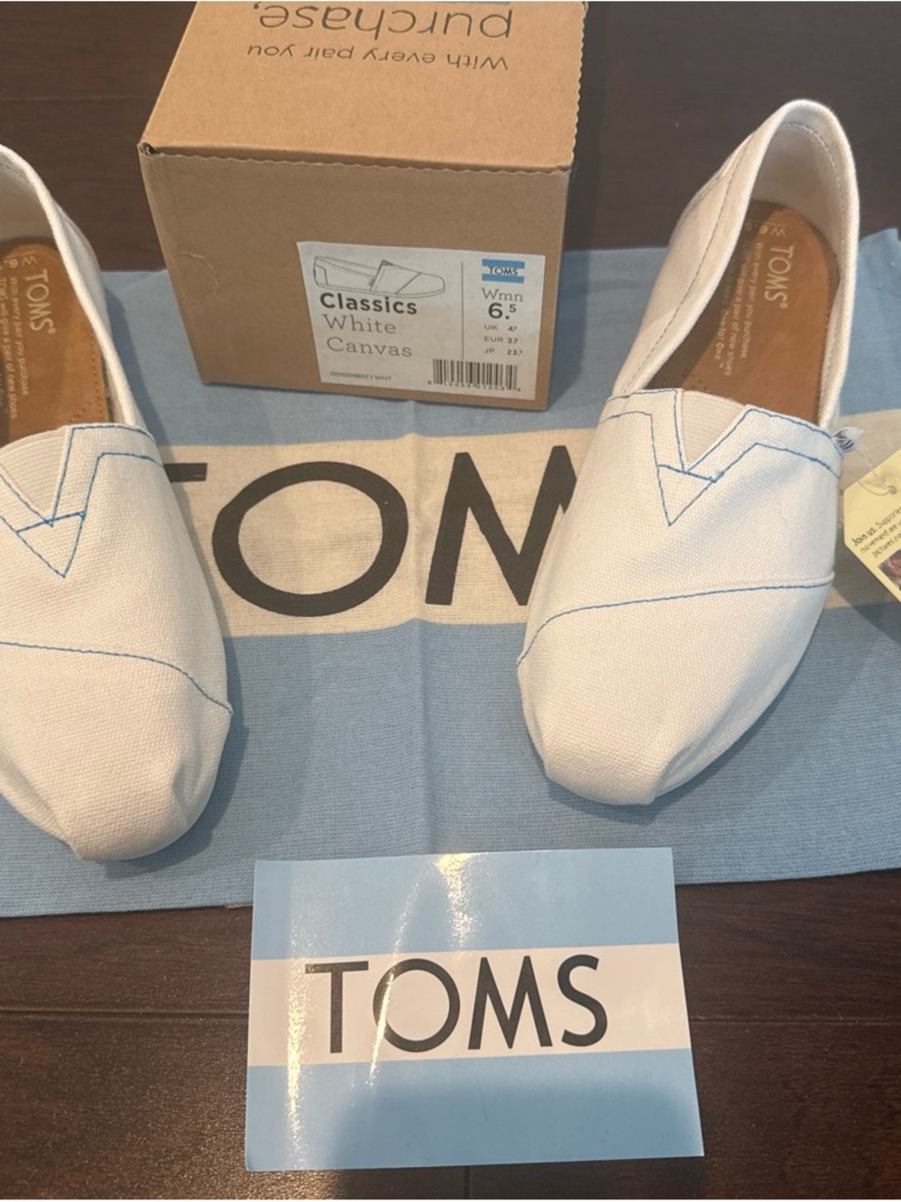 TOMS White Canvas Slip-On Shoes with Light Blue Stitching